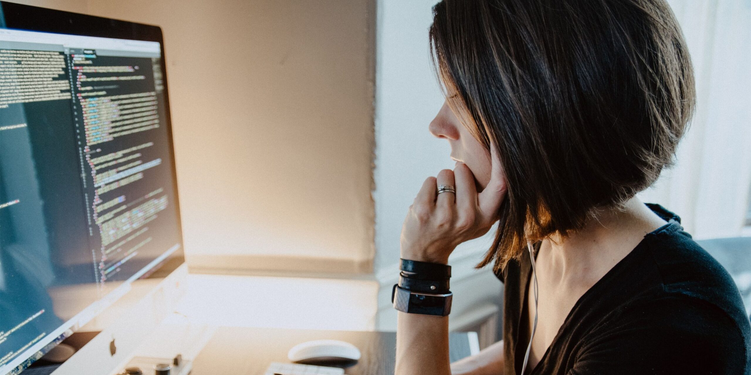 woman sitting in front of computer screens