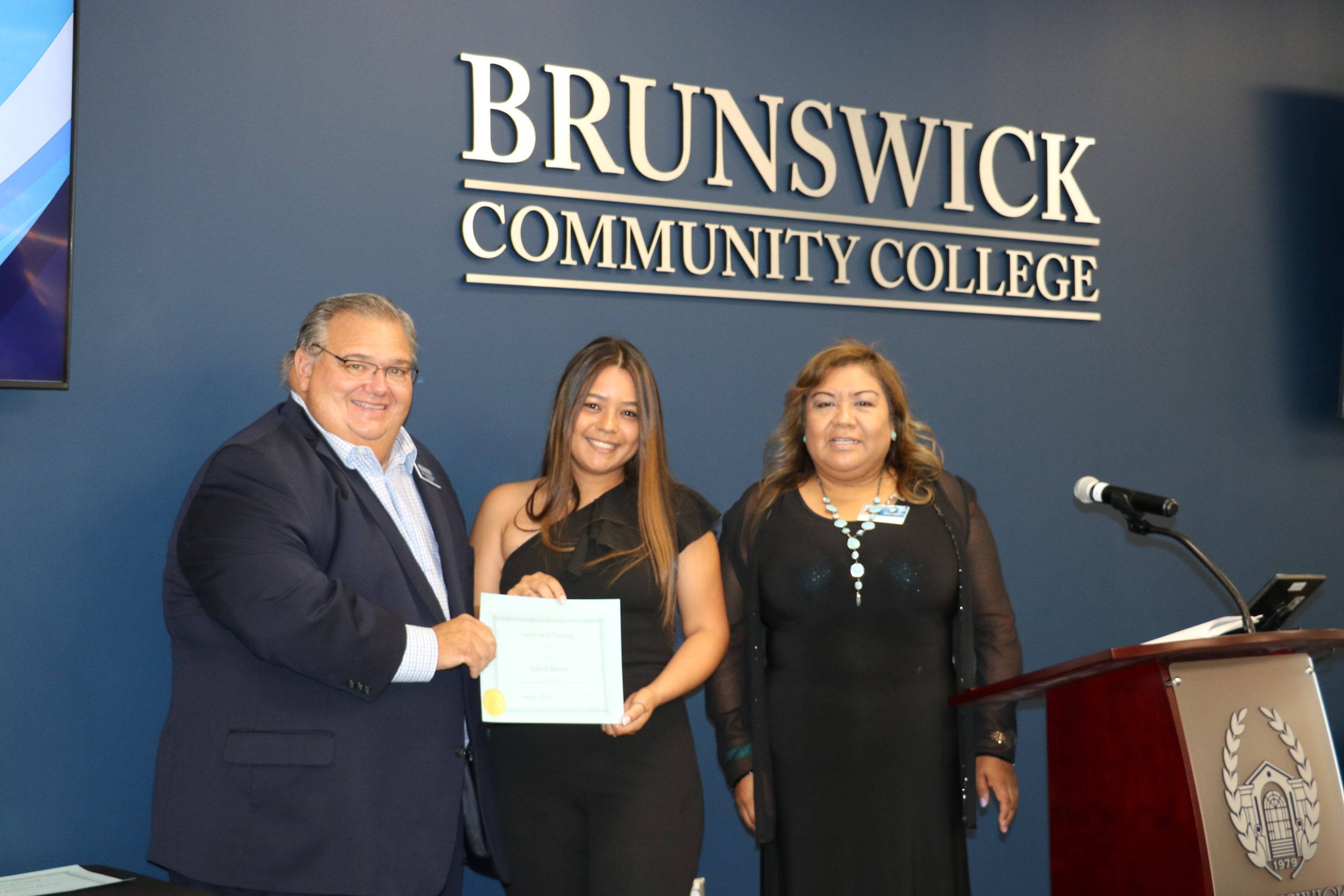 President Smith with a manicurist graduate and her instructor