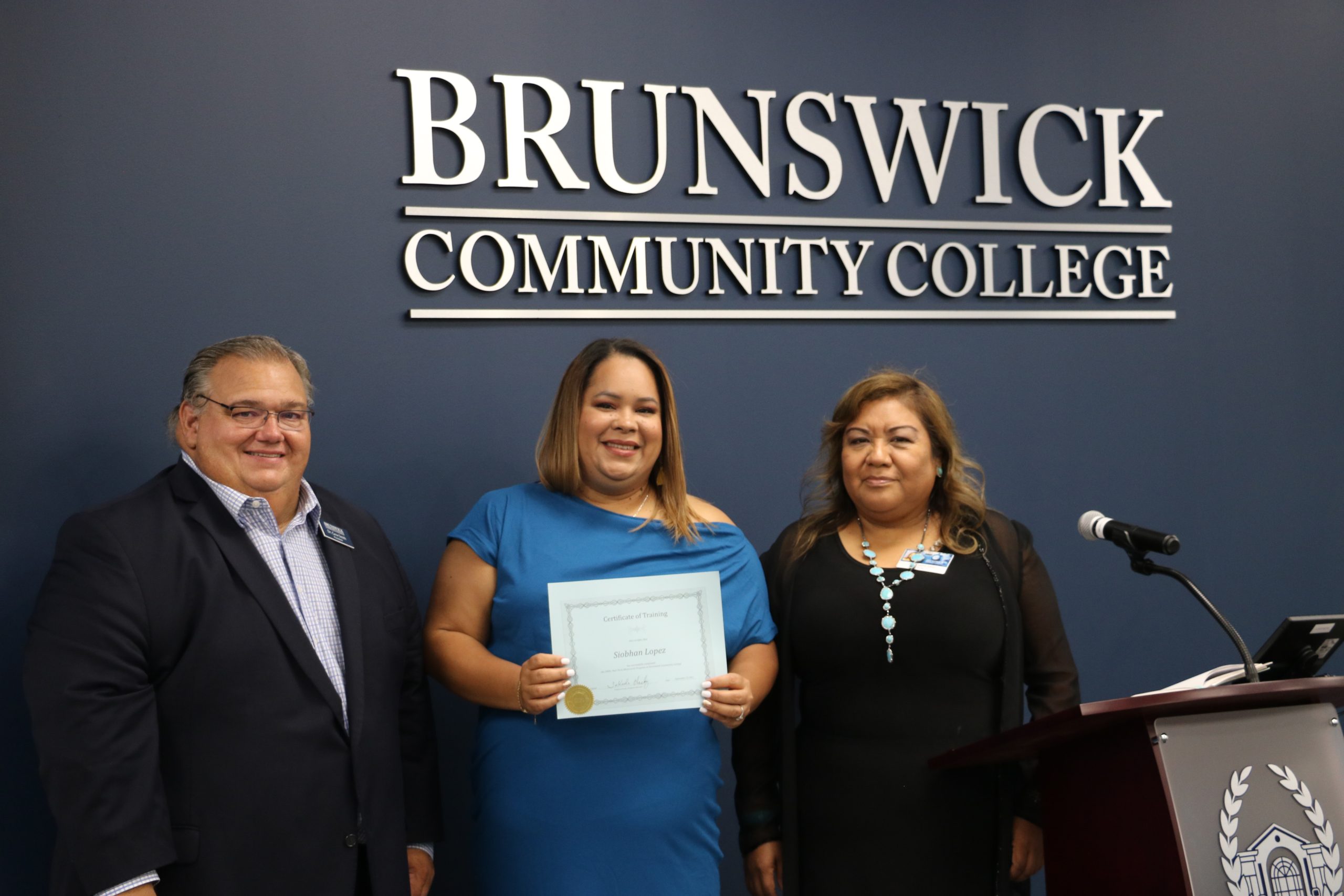 President Smith with a manicurist graduate and her instructor