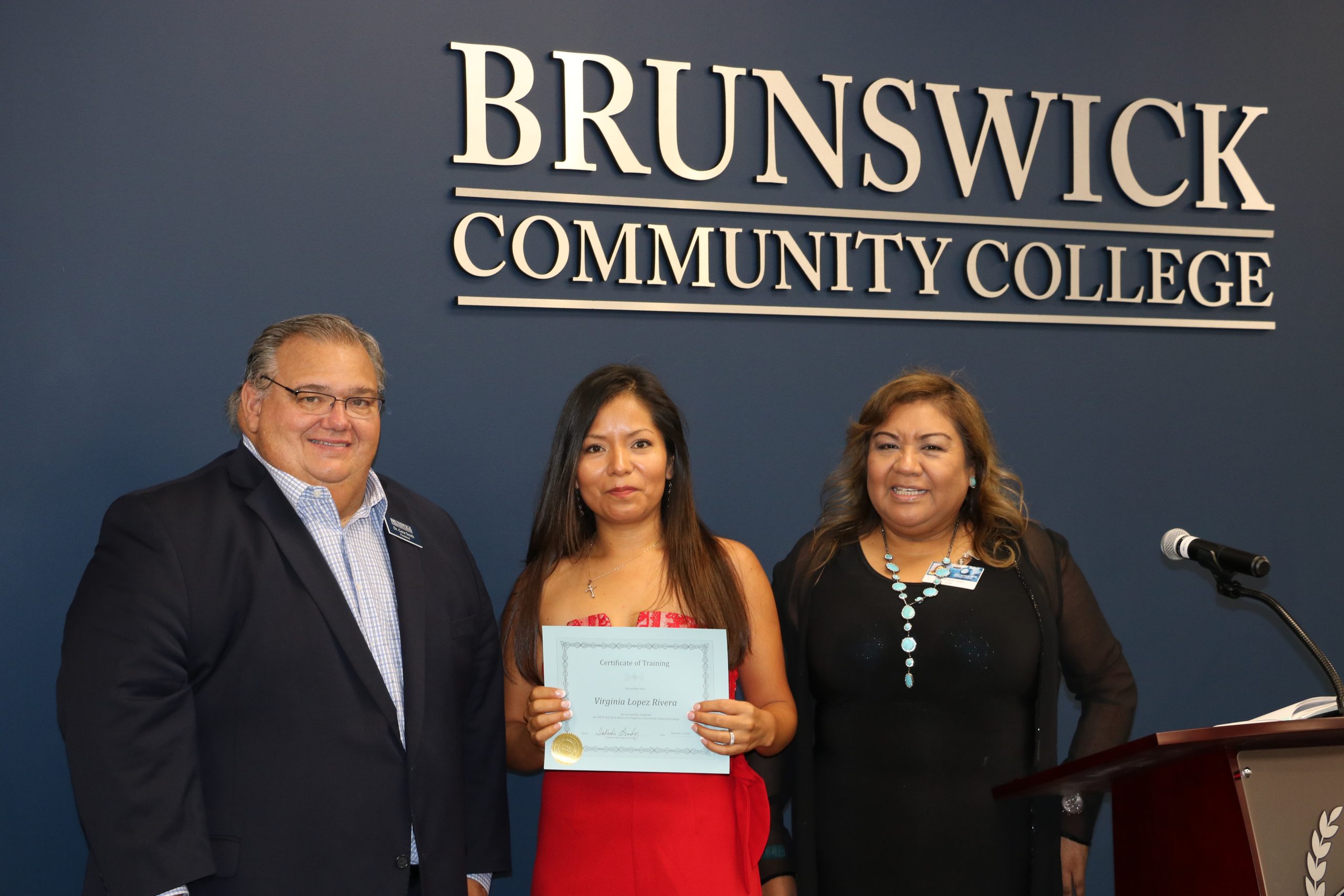 President Smith with a manicurist graduate and her instructor