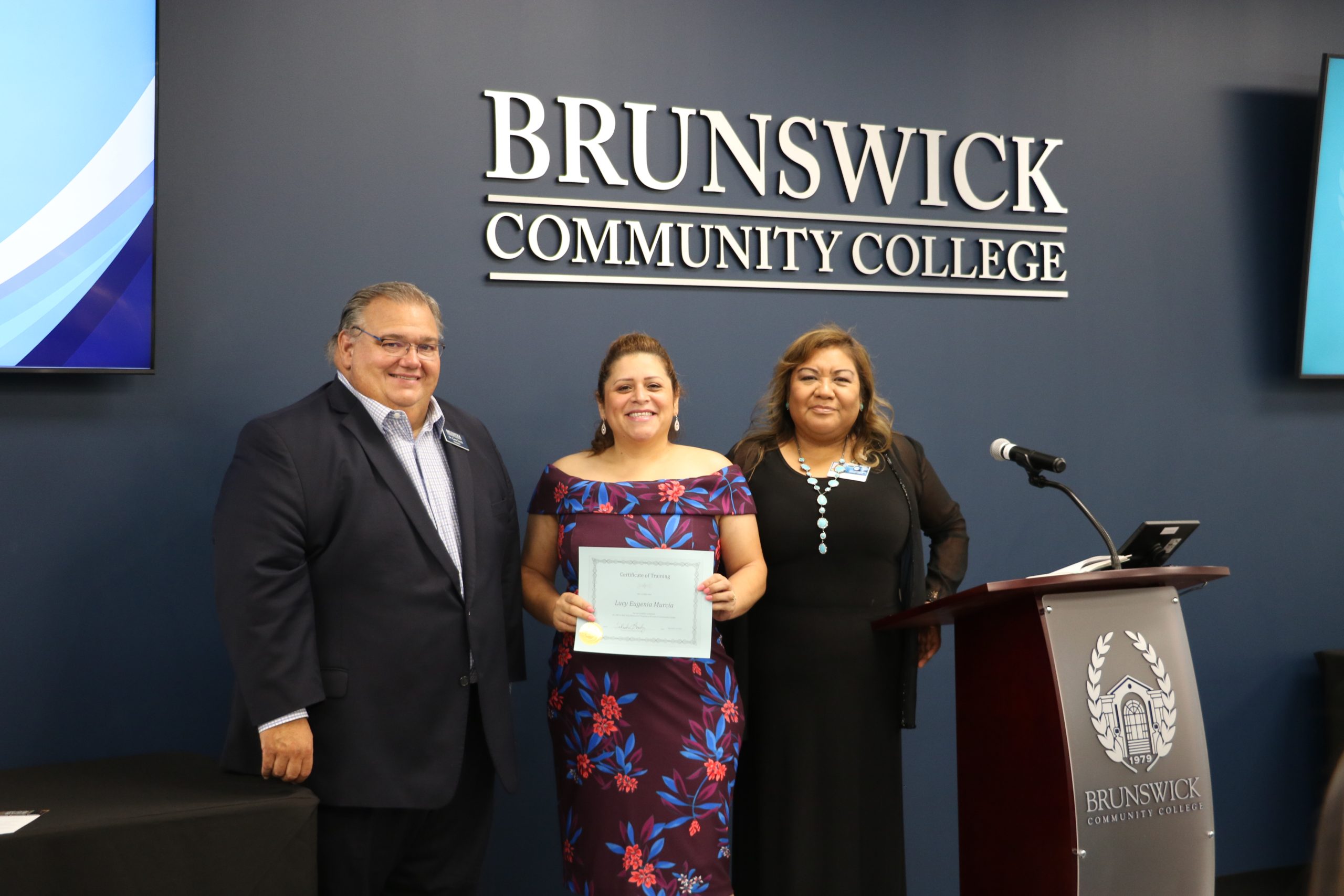 President Smith with a manicurist graduate and her instructor