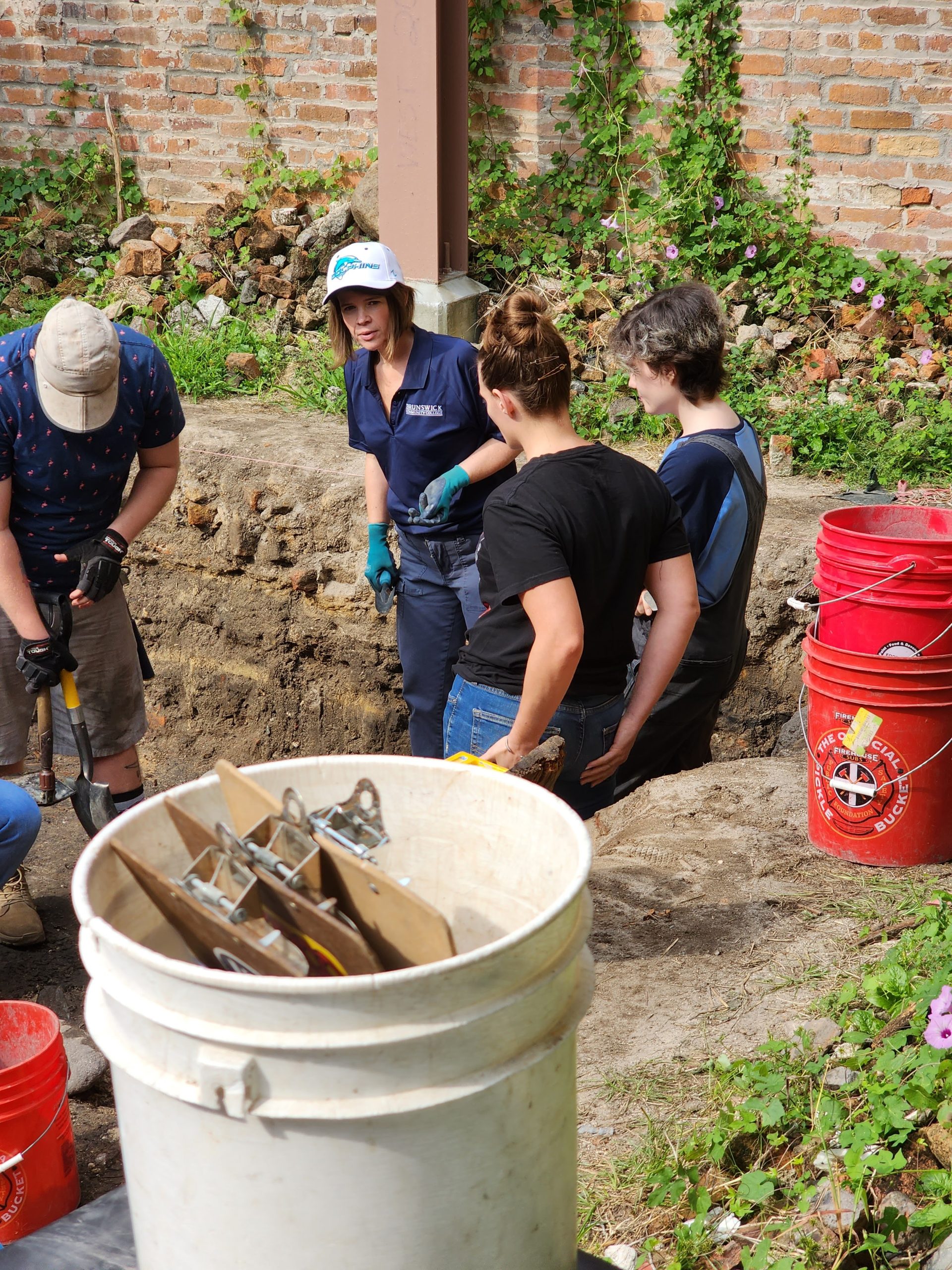 BCC instructor and students at an offsite field trip to an archeological dig