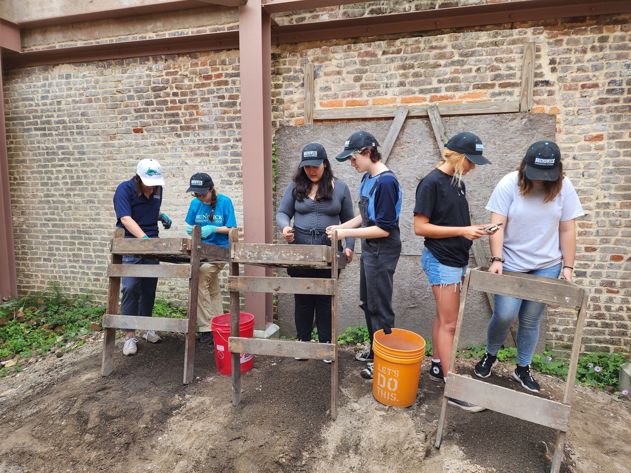 BCC instructor and students at an offsite field trip to an archeological dig