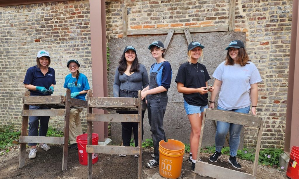 BCC instructor and students at an offsite field trip to an archeological dig