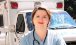 Nurse standing in front of a paramedic emergency vehicle