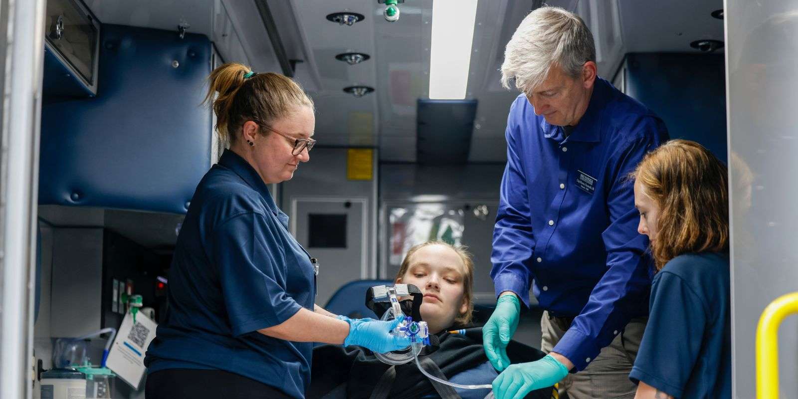 Instructor and three paramedics in ambulance
