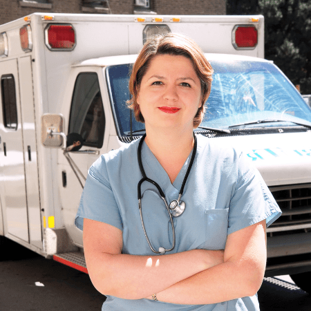 Nurse standing in front of a paramedic emergency vehicle