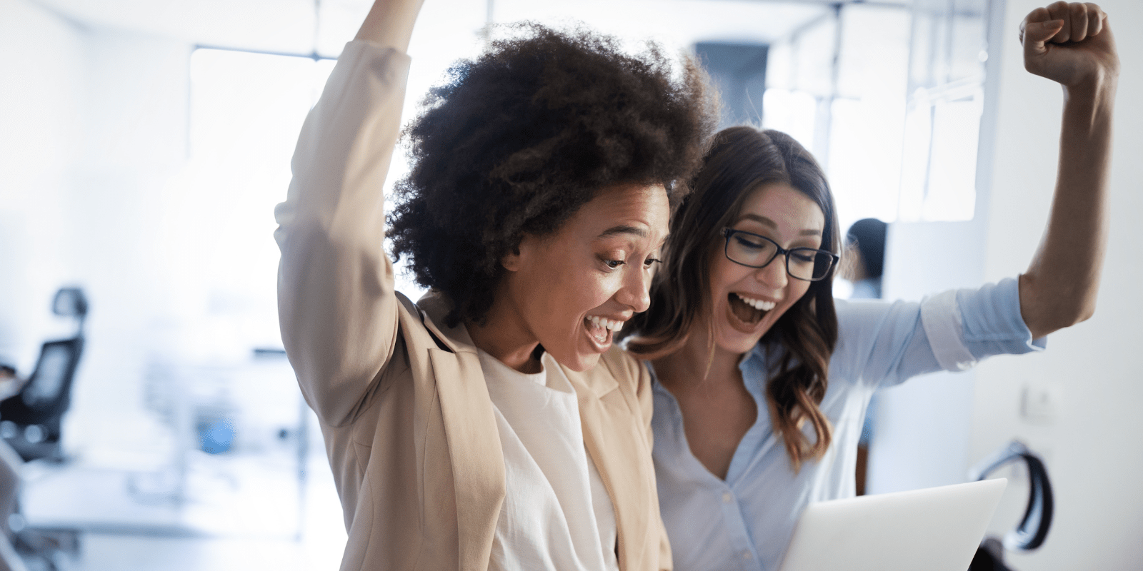 Two female small business owners celebrating success