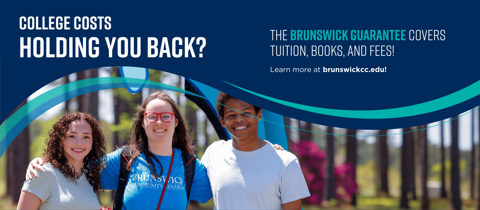 Three students standing by the Dolphin statue as part of a banner about Brunswick Guarantee