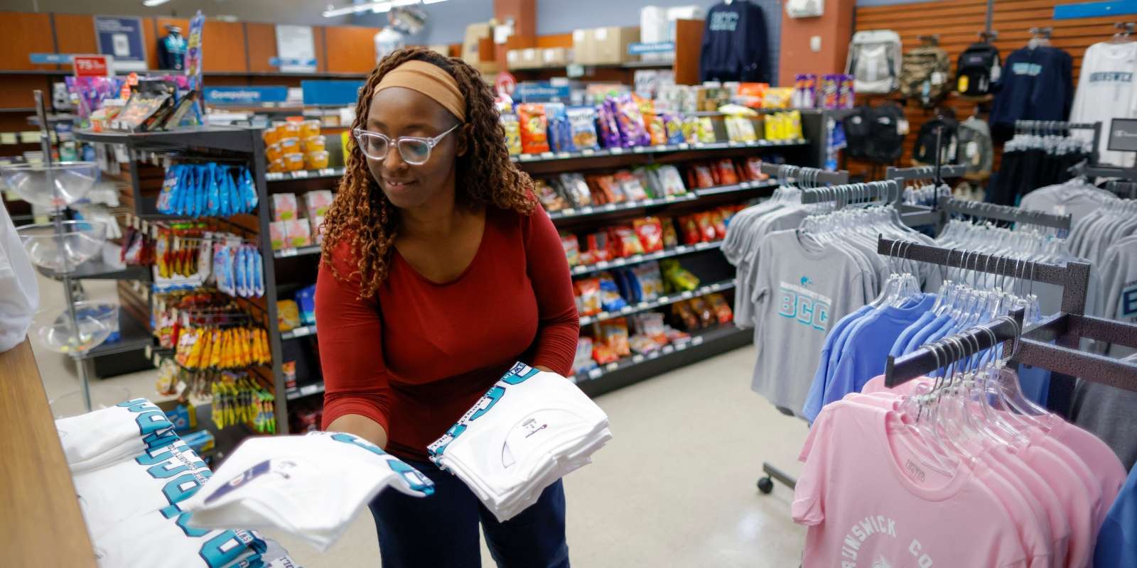 A BCC Campus Bookstore employee arranging items