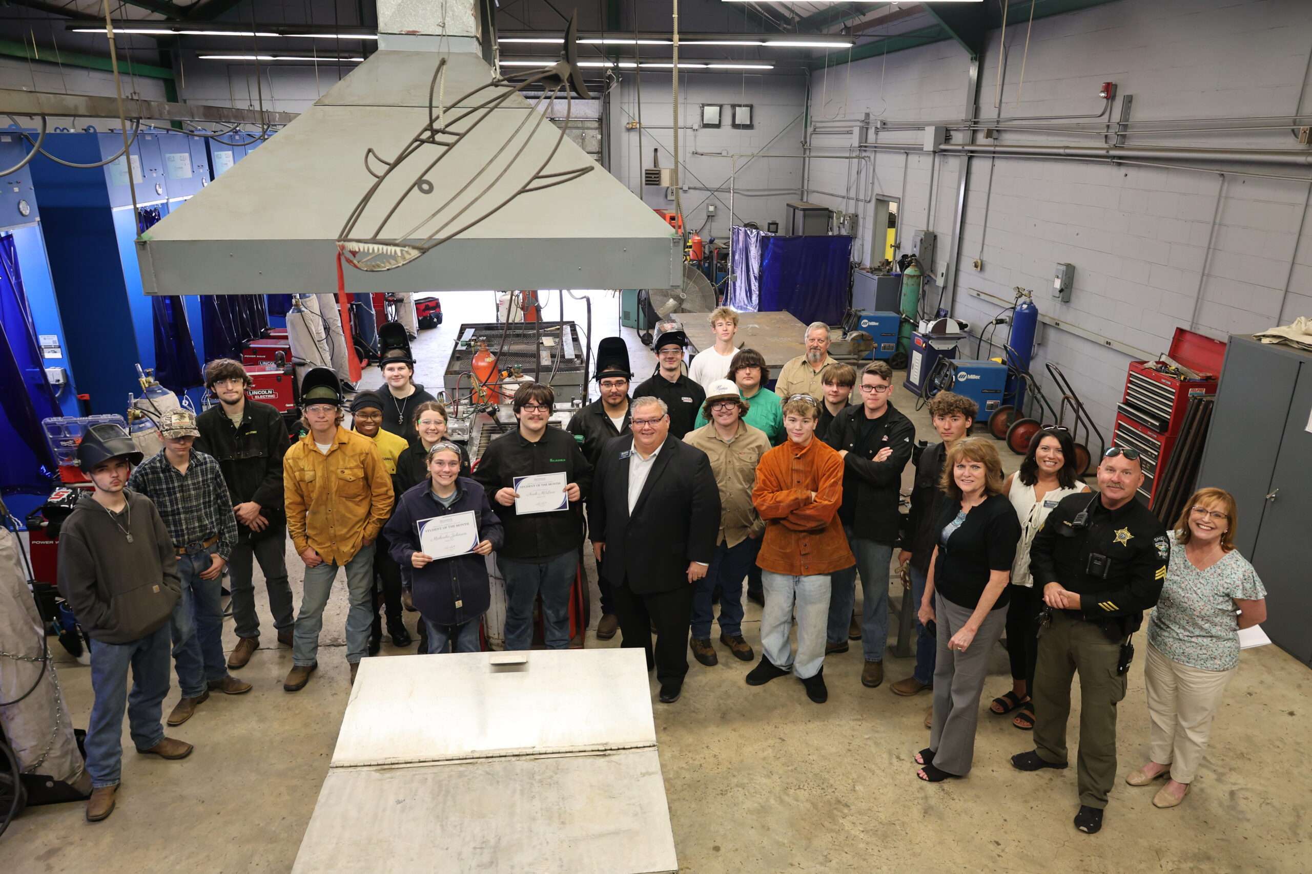 Welding students and student of the month honorees in a group photo taken in the welding lab