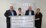 Dan and Linda Lynes presenting a $20,000 check in support of student scholarships