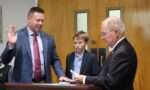 Justin Whiteside being sworn in as a BCC Trustee by Rep. Frank Iler and Walker Whiteside