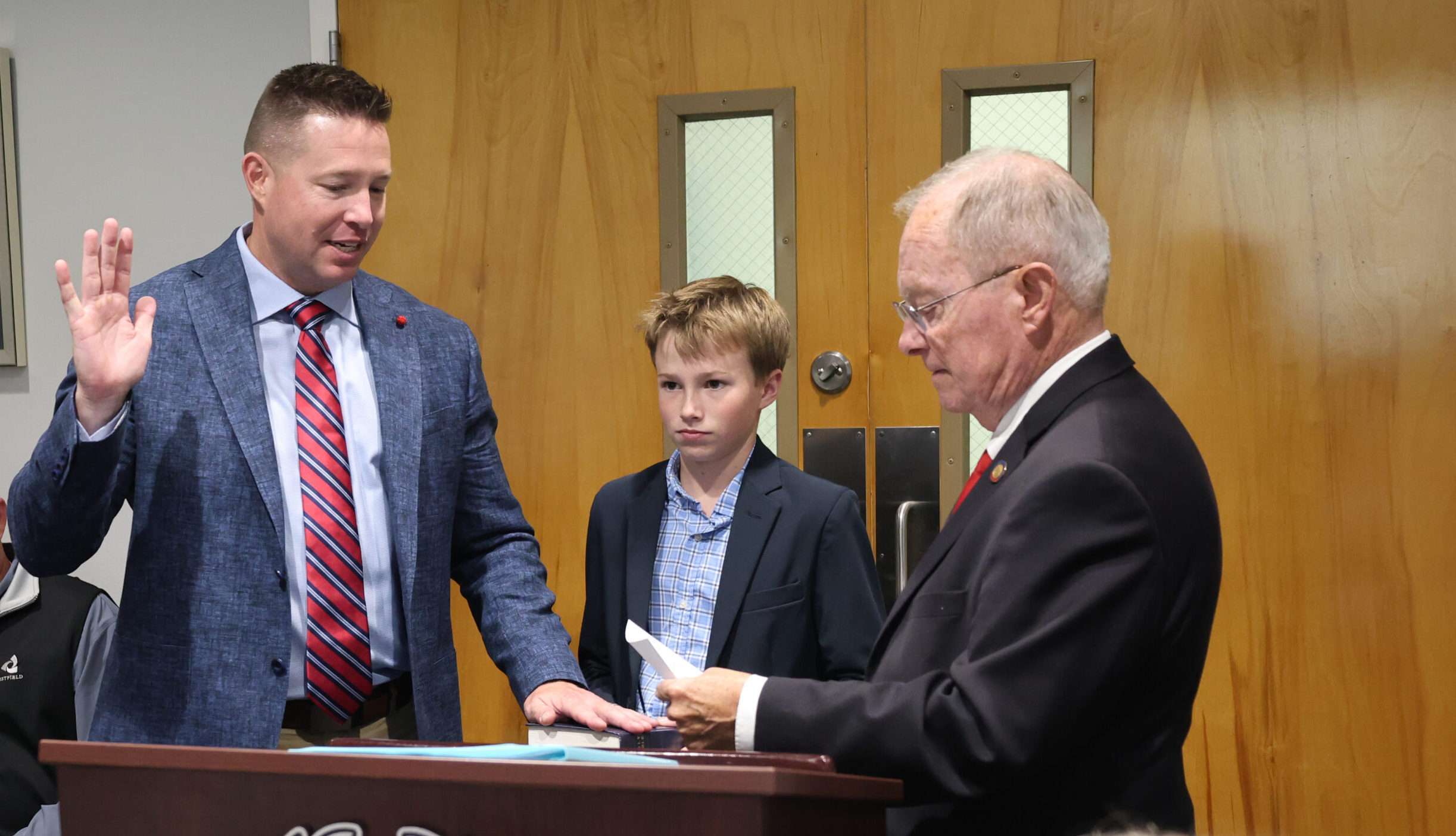 Justin Whiteside being sworn in as a BCC Trustee by Rep. Frank Iler and Walker Whiteside