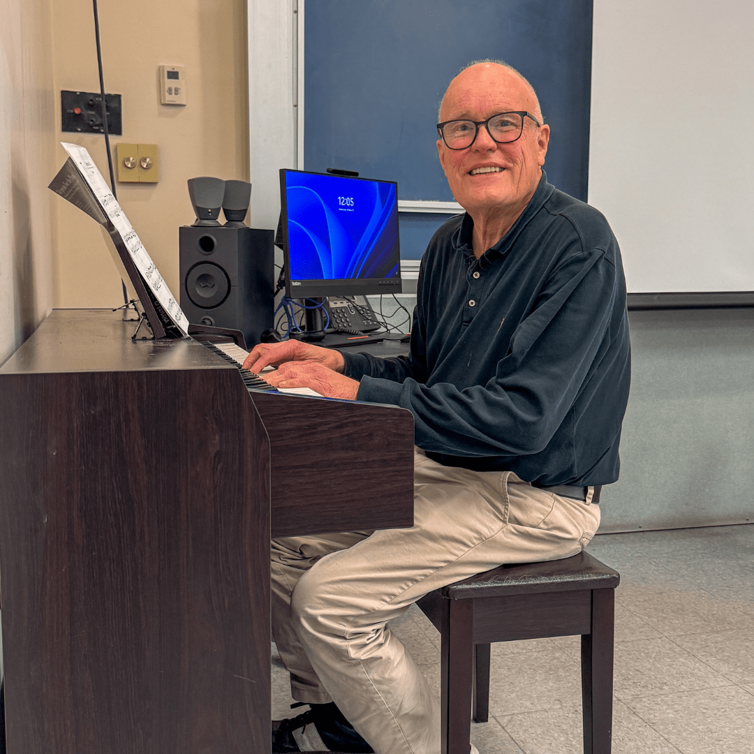 BCC Music Instructor sitting at a piano
