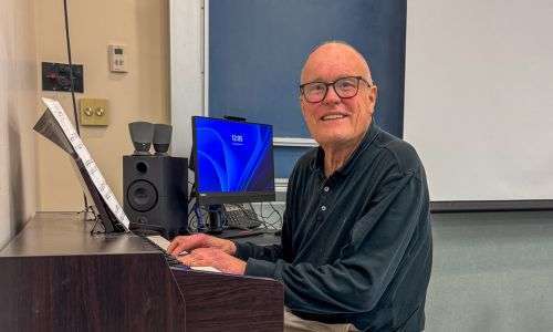 BCC Music Instructor sitting at a piano