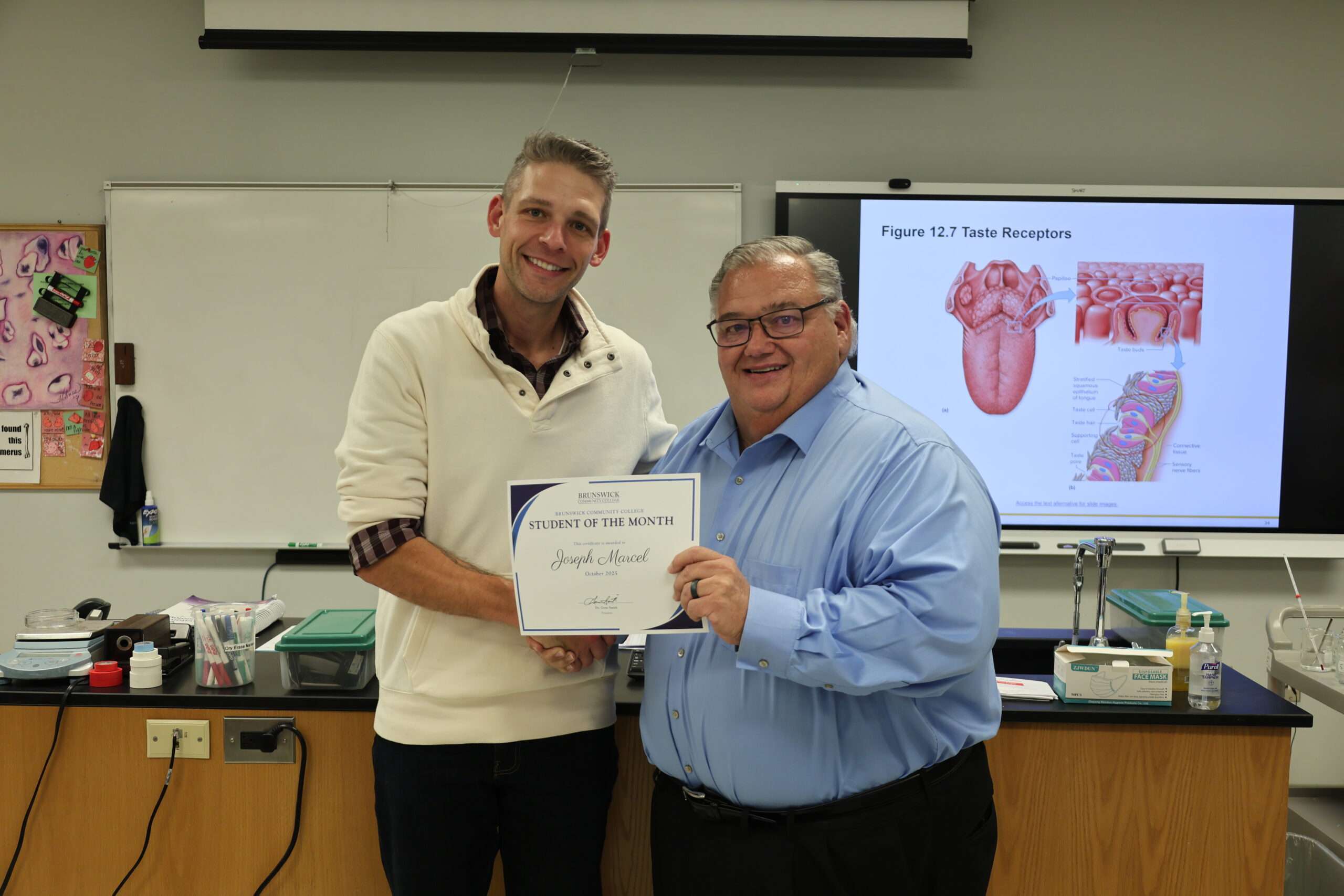 Joseph Marcel, student of the month with President Gene Smith