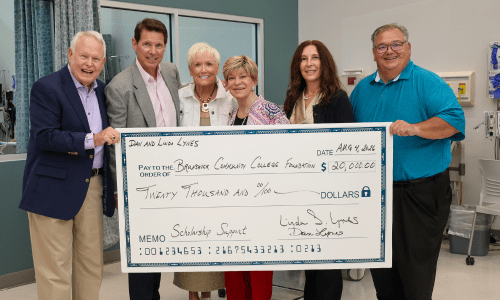 Dan and Linda Lynes, President Smith, Gabriella DiSisto, and John and Teri Daly holding a large check